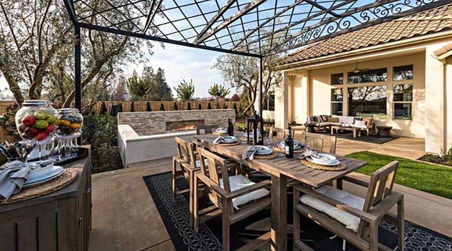 custom backyard landscape with dining table and fireplace